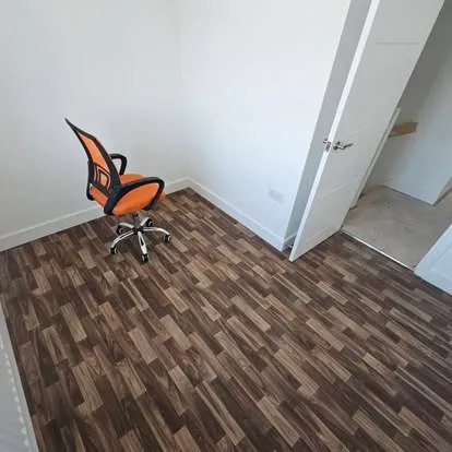 Dark wood-effect floor fitted in a home office
